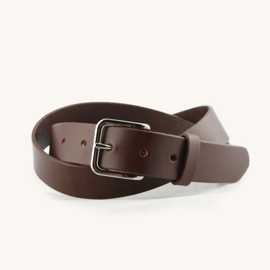 Cognac brown leather belt with a silver-tone rectangular buckle, casually coiled.