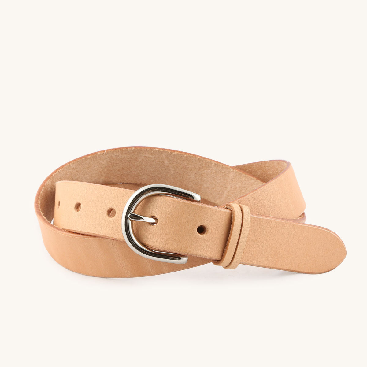 Natural leather Meridian Belt with a silver-toned buckle, coiled on a white background.