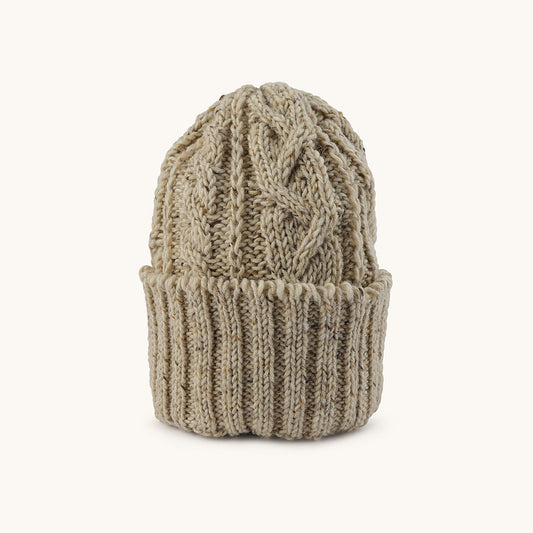 Oatmeal cable knit cap with ribbed cuff and speckled yarn texture, front view.