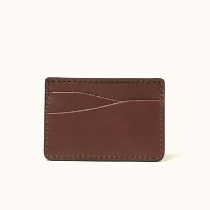Cognac leather card holder wallet with multiple diagonal card slots and stitched edges.