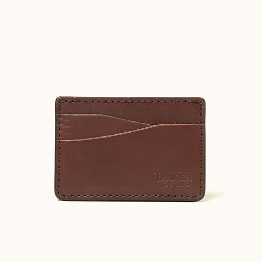 Cognac leather wallet by Tanner Goods with multiple card slots, visible stitching, and embossed logo.