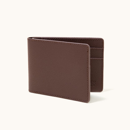 Cognac recycled leather bifold wallet, partially open, showing interior card slots and fine pebbled texture.