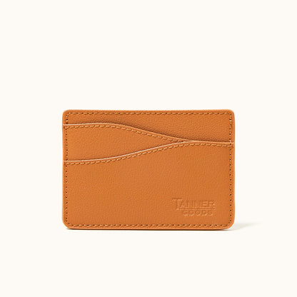 Saddle tan recycled leather card holder by Tanner Goods, featuring a pebbled texture, visible stitching, and multiple card slots.
