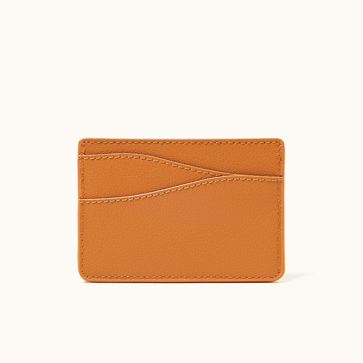 Saddle Tan recycled leather wallet with pebbled texture, multiple card slots, and visible stitching.