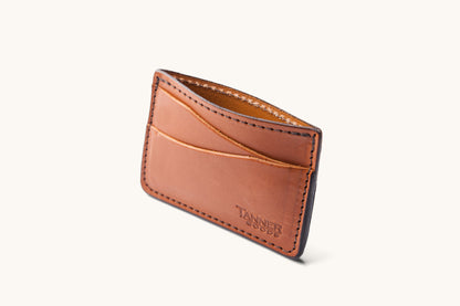 Saddle tan leather cardholder wallet by Tanner Goods, with multiple slots and dark stitching.