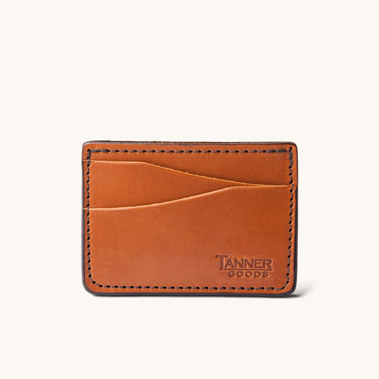 Saddle tan leather card holder by Tanner Goods with visible stitching and multiple card slots.
