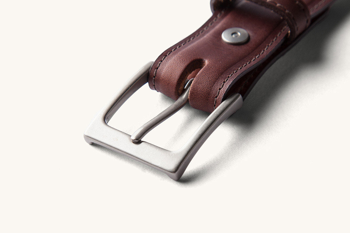 silver buckle on brown belt