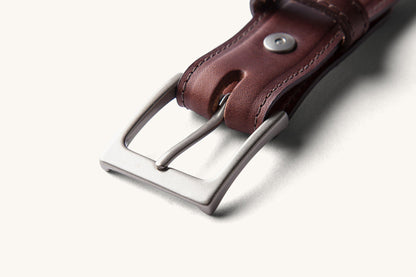 silver buckle on brown belt