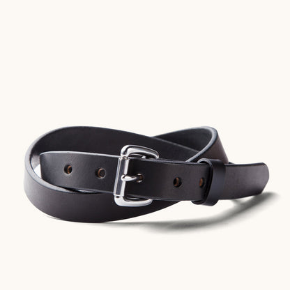 Black skinny standard belt made of smooth leather, with a polished silver buckle, coiled to show punched holes.