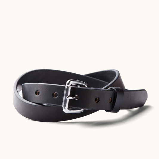 Black skinny standard belt made of smooth leather, with a polished silver buckle, coiled to show punched holes.